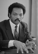 Jesse Jackson, half-length portrait of Jackson seated at a table, July 1, 1983