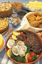 Several plates full of various cereals, fruits and vegetables on a table.