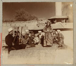 Samarkand A group of musicians playing for a bacha dancing boy