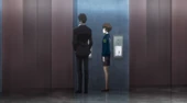 Tsunemori and Kogami in front of the elevator.