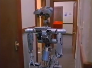 Johnny 5 going through the halls of the police station