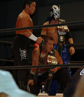 Mochizuki as the Open The Triangle Gate Champions with Don Fujii and K-ness.