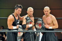 Taku Iwasa, Shinobu and Kenichiro Arai as Open The Triangle Gate Champions