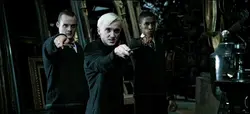 Draco Malfoy, Gregory Goyle, and  (who replaced Vincent Crabbe in the film) corner Harry