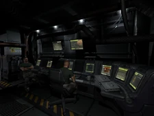 Two Marines sitting at one of Hannibal's many consoles.