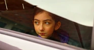 Peyton sitting in her parent's car