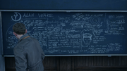 Jack stands before a lecture hall blackboard detailing the story of Alan Wake.