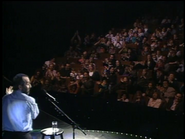 Raffi and the audience clapping their hands for the rain