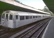 A 1960 Tube Stock train in white livery on an off-peak Woodford to Hainault service.