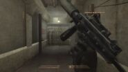 The MP9 being reloaded in R6V1. This MP9 is fit with a reflex scope and a suppressor.