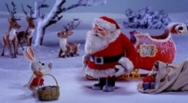 Santa Claus receiving an Easter egg from Peter Cottontail in his first Easter appearance.