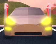 The Model 3 with its headlights on.