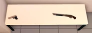 The weapons table, with the pistol and shotgun on it.