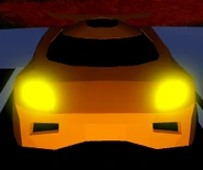 The front view of the Torpedo with its headlights on at nighttime.