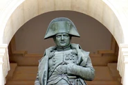 A statue of Napoleon at Les Invalides. His hand in waistcoat pose can be seen.