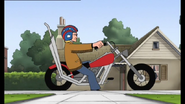 A young Phillium rides up on his motorcycle.