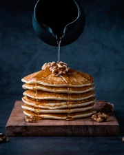 Foodiesfeed.com pouring-honey-on-pancakes-with-walnuts