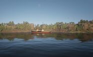 Ein Dampfschiff passiert den Fluss auf Höhe des Van Horn Trading Post