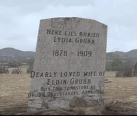 Lydia Grubb gravestone with advertising for Eldin Grubb. Note that the inscription is too wide for the headstone.