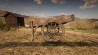 The wooden cart and the outhouse