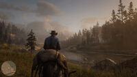 Arthur on his horse at the edge of a river