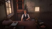 Sheriff Palmer at his desk after a bounty hunting mission