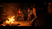 Javier Escuella (left), Uncle (middle) and Arthur Morgan sitting around a campfire