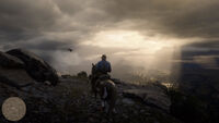 Arthur and his horse on a cliff taking in the view