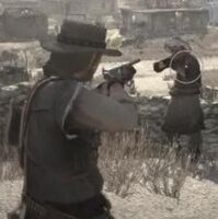 Marston aiming the shotgun to an attacker.