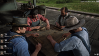 Arthur playing dominoes with three other guys.