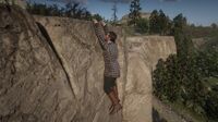 Jimmy Brooks hanging on a cliff