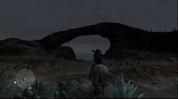 Marston looks through the Ojo del Diablo.