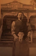 Feeney and his son in front of their gun store