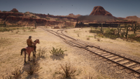 Arthur Morgan observing a train in New Austin