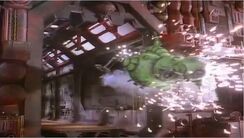 The shuttlecraft Starbug 2 smashes by the Red Dwarf hangar door