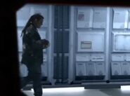 Lister walks down a corridor and by a large porthole window ("Back to Earth")