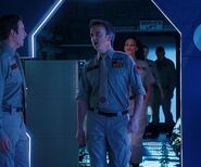 Officer Bradley emerges into White Corridor 159 from a service lift and orders Rimmer back to work ("Skipper", Series XII)