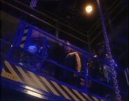 Kryten, Rimmer and Cat descend into the cargo bays on a scaffolding lift ("Polymorph")