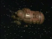 Kryten's dismembered hand leaves the Psi-moon to fetch help from Red Dwarf in an ore sample pod ("Terrorform", Series V)