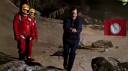 On Planet Rimmer, Rimmer tries to scoop up valuable soil as a sandstorm blows in (Timewave)
