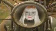 Holly in Rimmer's space bike display ("Meltdown", Series IV)