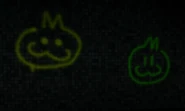 Graffiti of two cat heads. The left one is yellow and the right one is lime green.
