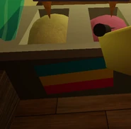 An upside-down pansexual flag behind Crem's counter.