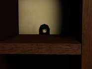 Rat in Lobby.png (265 KB) A tiny version of RAT seen peeking on a hole behind the shelves in the shop.