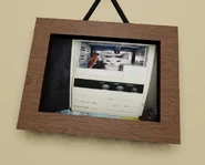 A painting in the room, showing a cat in a computer.