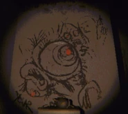 Graffiti of some humans and a strange looking creature with partially obscured text reading "Your Turn". (The creature shares a passing resemblance to the Oogly)