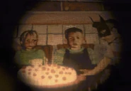Art showing a kid wearing a mask resembling Batman, passing a birthday cake (possibly the Birthday Boy).