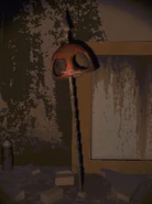 A dead semibots head impaled through with a spear..