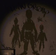 Graffiti depicting three silhouettes of humans.