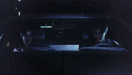 Leon and Claire driving in a car
